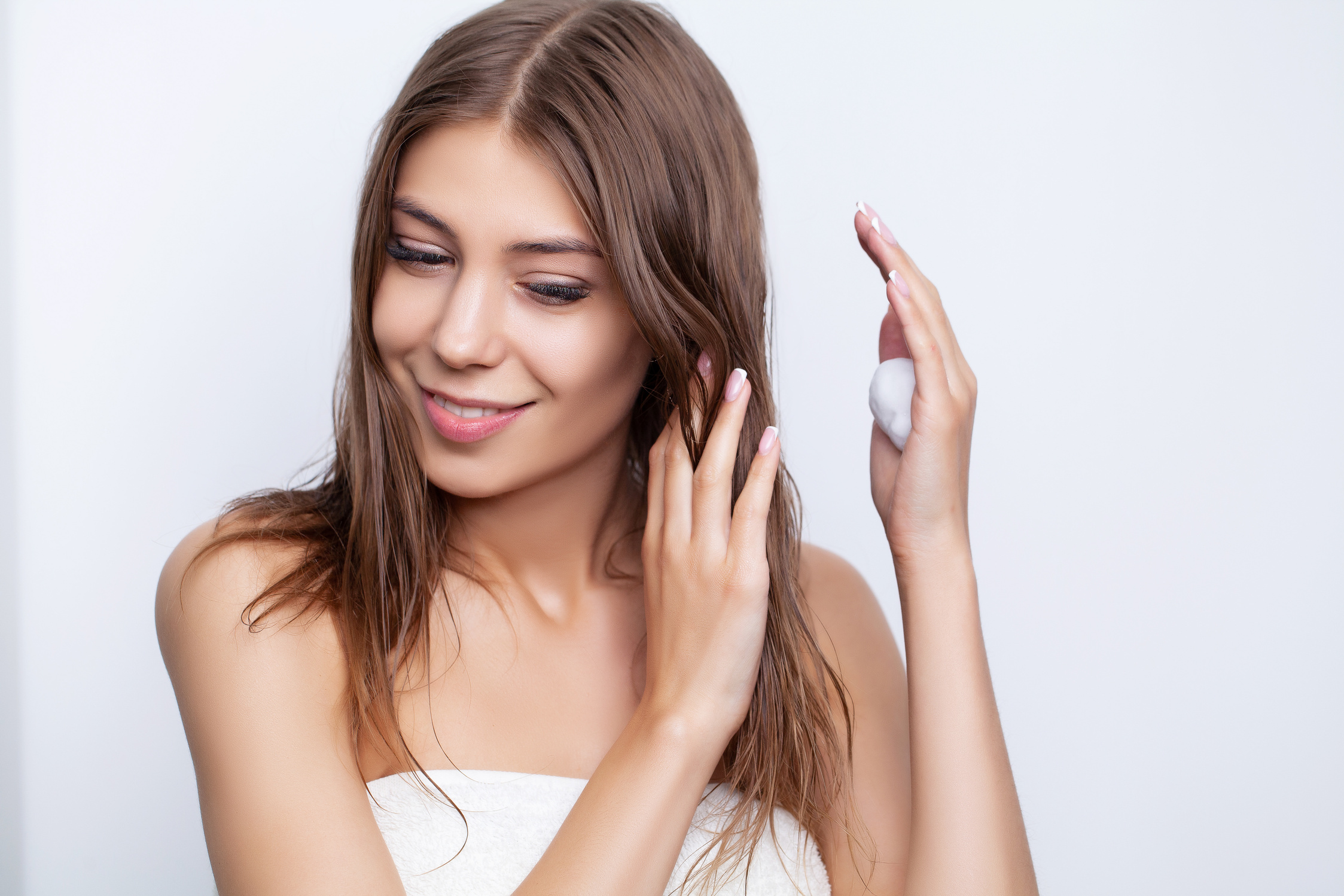 Young Woman Takes Care of Her Hair Using Natural Oils and Conditioners for Hair Care